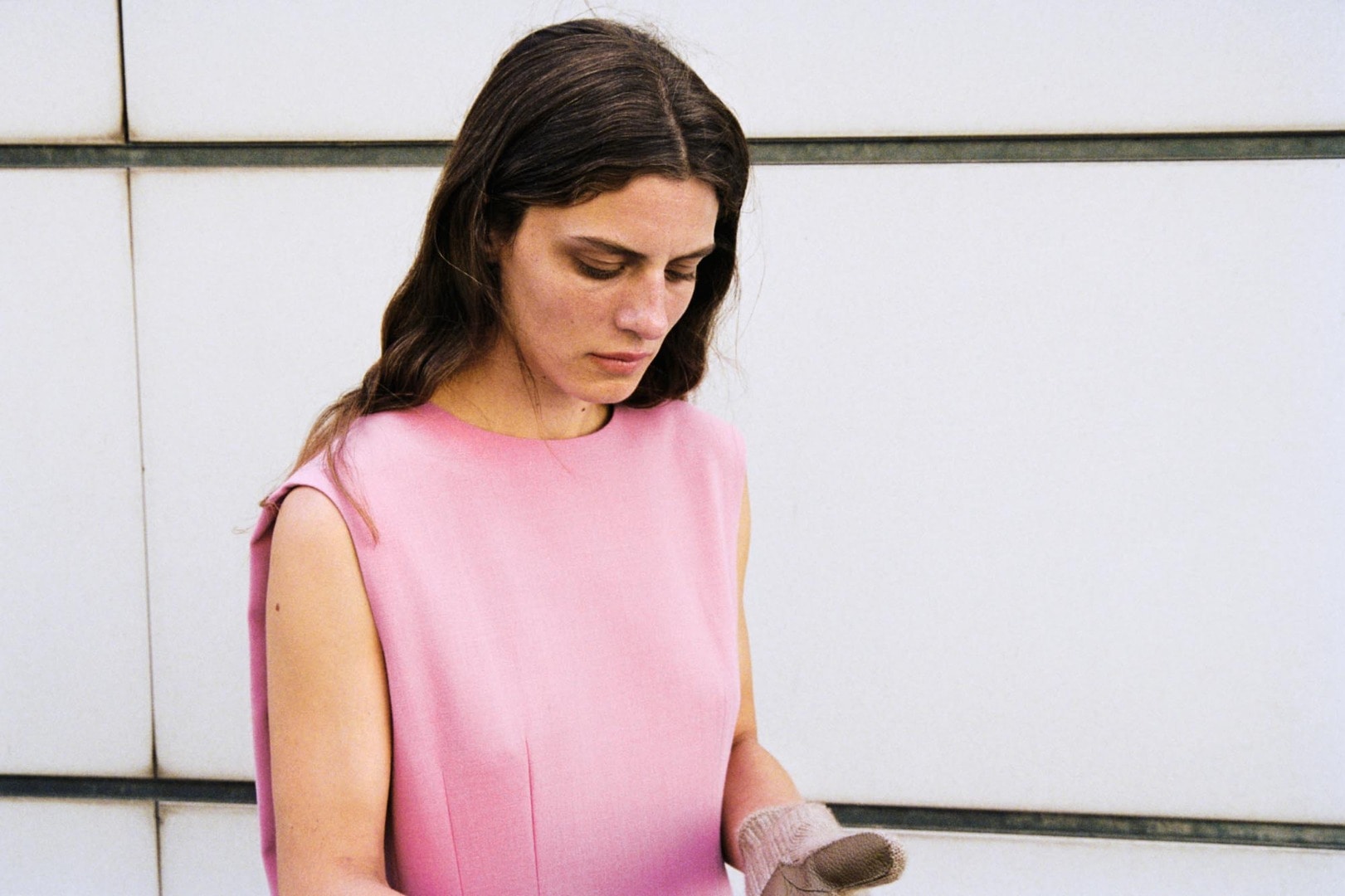 Marie wears Tense Wool Double Cloth Dress in Pink and Baby Cashmere Knit Leather Gloves in Natural Brown