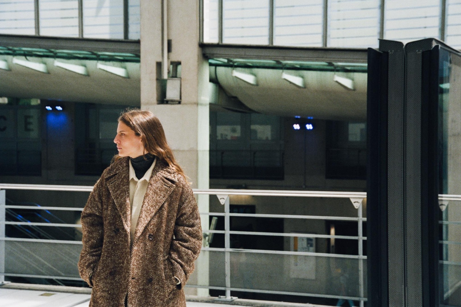 Marie wears Wool Alpaca Herringbone Tweed Double Coat in Brown Herringbone, Shetland Wool Organic Cotton Woven Cloth Shirts Blouson in Ivory and Kid Mohair Sheer Knit Turtle in Top Charcoal