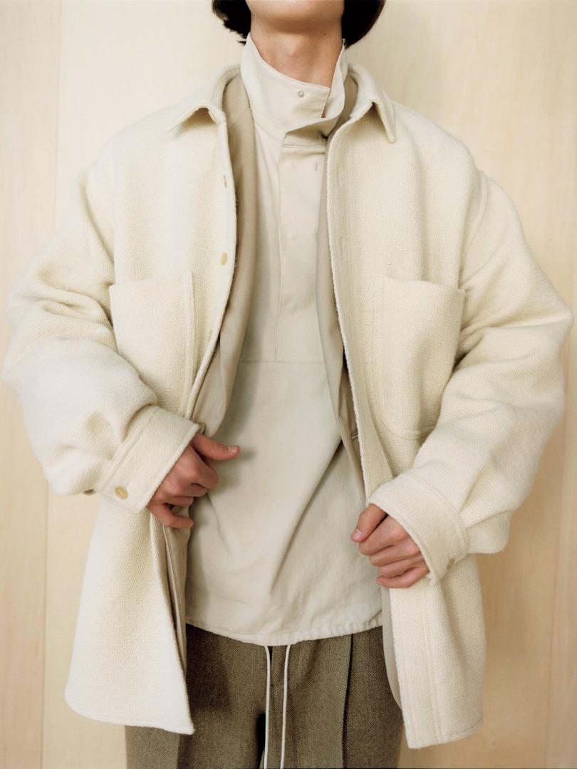 Kaan wears Shetland Wool Organic Cotton Woven Cloth Shirts Blouson in Ivory