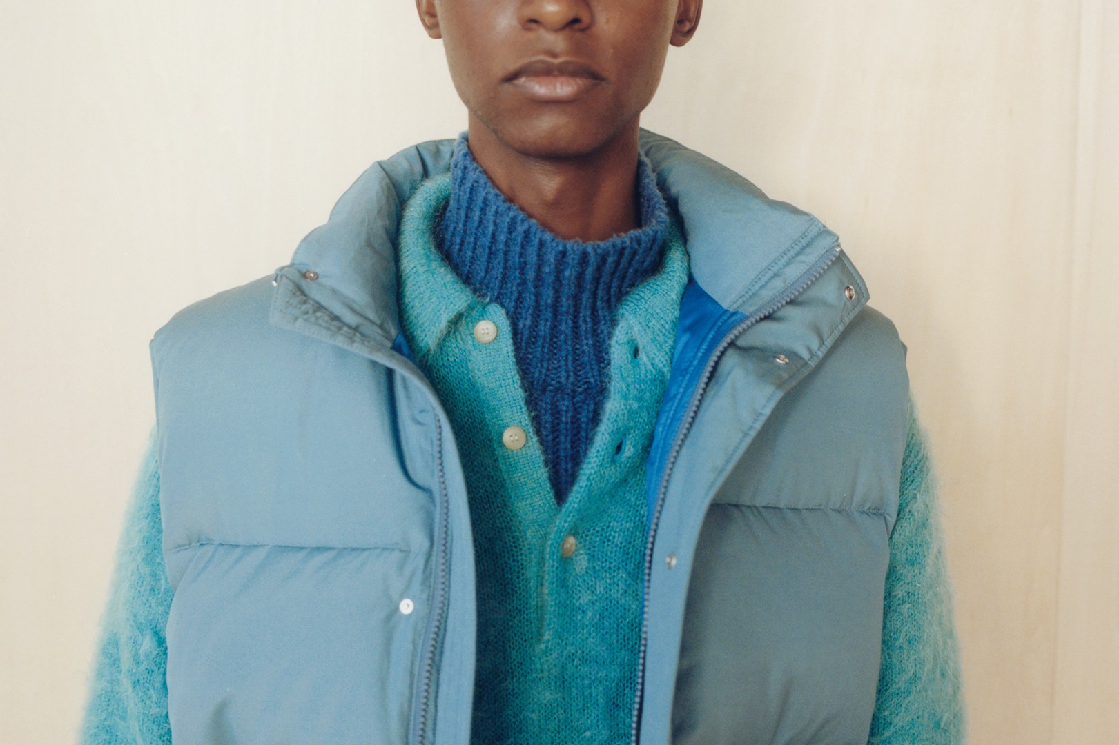 Mohamed wears Suvin High Count Cloth Down Vest in Cerulean Blue, Brushed Super Kid Mohair Knit Polo in Blue