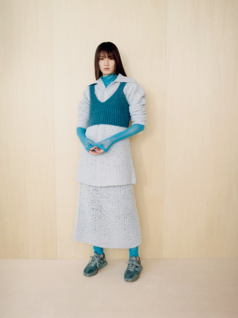 Miki wears Milled Wool Mole Knit Long Cardigan in Light Blue, Milled Wool Mole Knit Skirt in Light Blue, Wool Baby Camel Brushed Yarn Knit Camisole in Blue