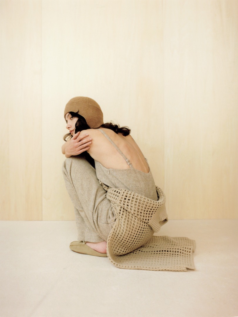Liz wears Wool Hairline Light Tweed Overalls in Top Ivory, Brushed Baby Camel Melton Hand Sewn Cap in Camel