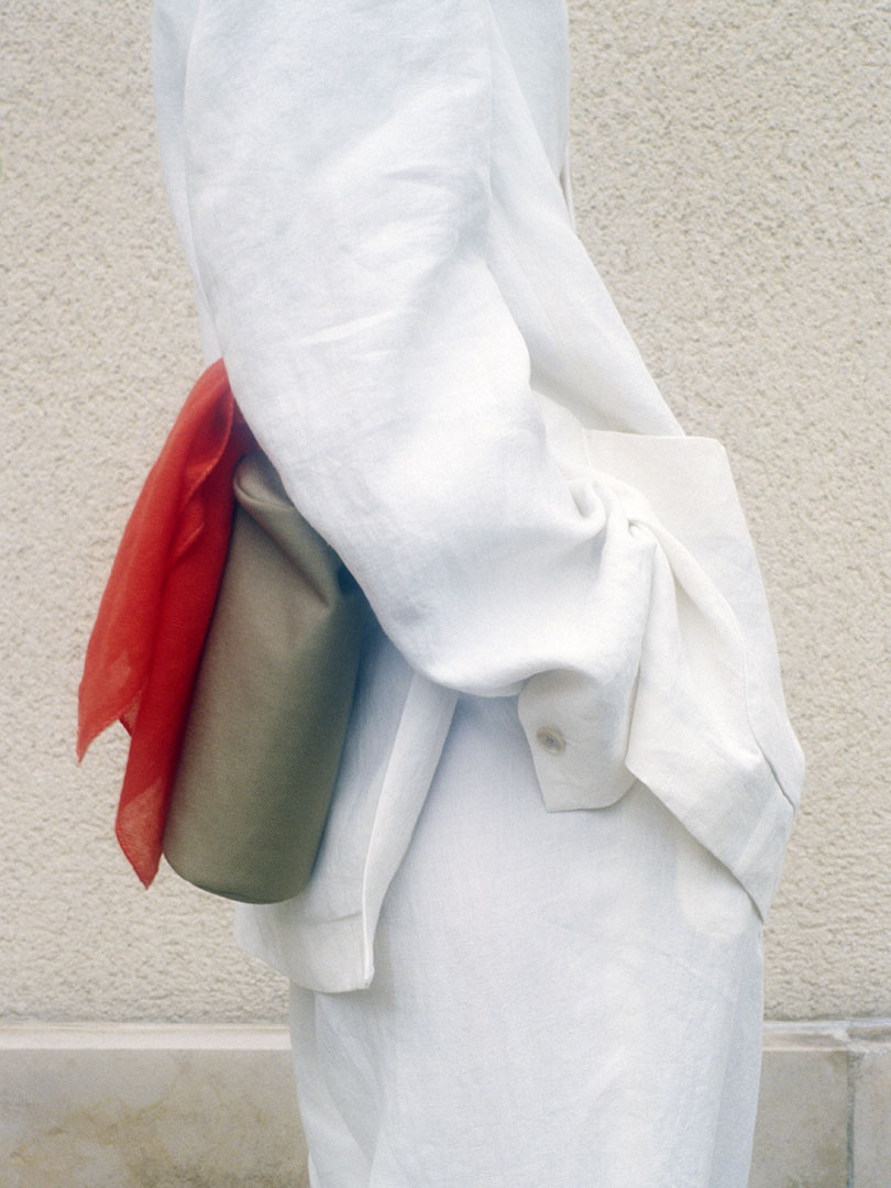 Hsiang wears Pouch Set Made By Aeta in Beige, White Cashmere Gauze Mini Scarf in Red