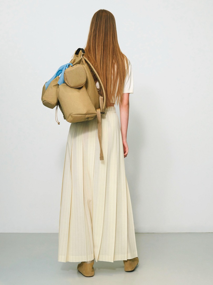 Charlotte wears Small Backpack Set Made By Aeta in Beige