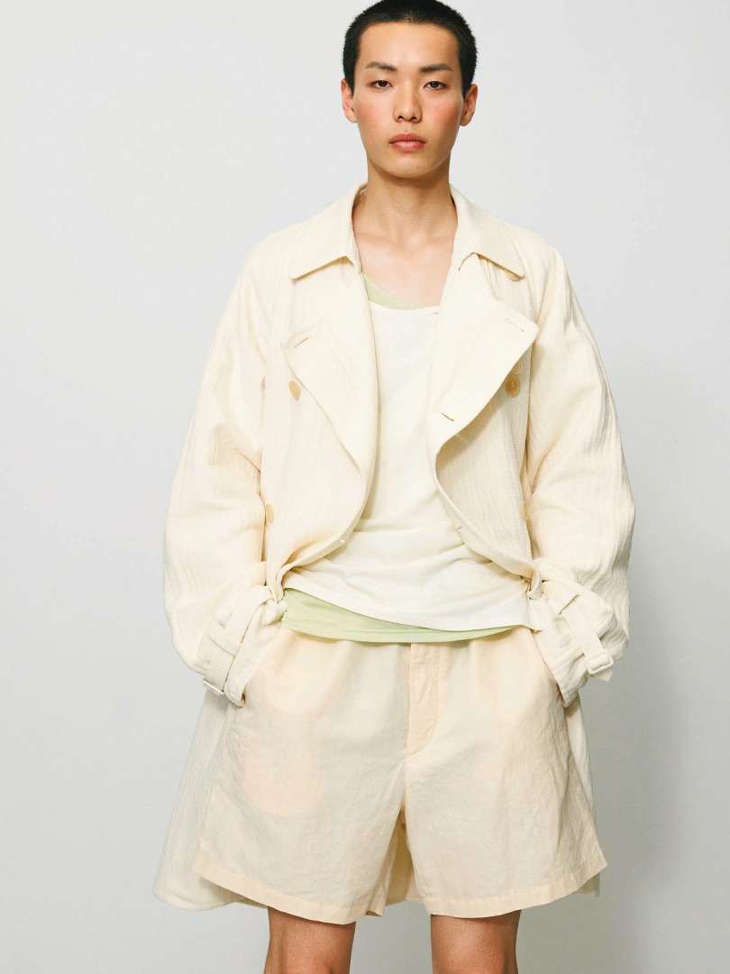Yuta wears Cotton Mole Melton Hand Sewn Coat in Ivory White, High Density Finx Linen Weather Easy Shorts in Ecru