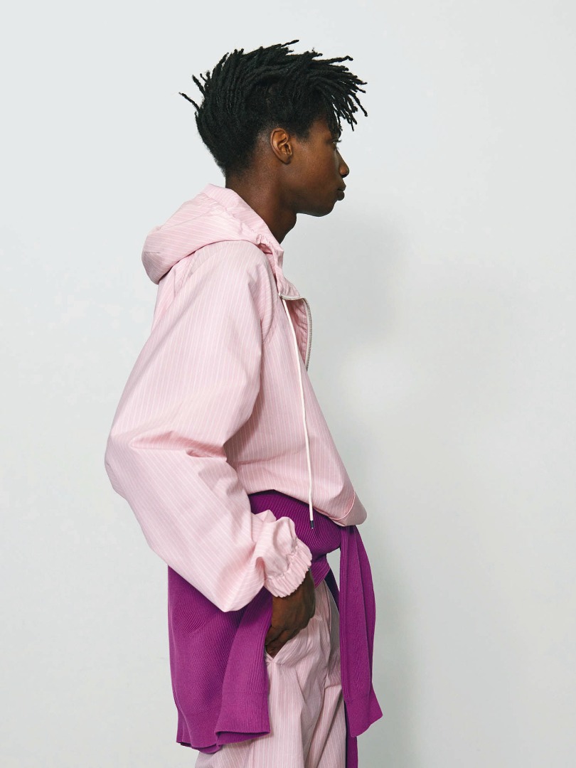 Sidy wears Finx Polyester Stripe Hooded Zip P/O in Pink Beige Stripe